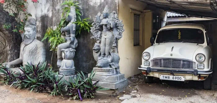 Framed Print : Granite stone carvings and an Ambassador car in a garden at Mamallapuram in Tamil Nadu, India