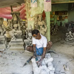 A stone carver at Mamallapuram in Tamil Nadu, India