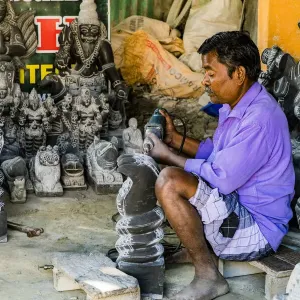 A stone carver at Mamallapuram in Tamil Nadu, India