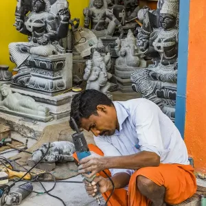 A stone carver at Mamallapuram in Tamil Nadu, India