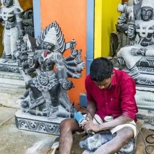 A stone carver at Mamallapuram in Tamil Nadu, India
