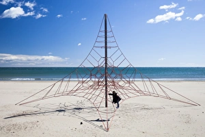 Spain Prints: A child playing on a climbing frame in Peniscola, Spain