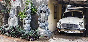 India Prints: Granite stone carvings and an Ambassador car in a garden at Mamallapuram in Tamil Nadu