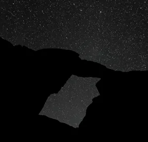 A night-time picture of a natural arch at Wadi Rum, Jordan