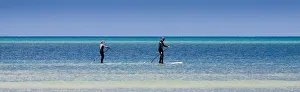 Two paddleboarders at Orewa in Auckland Region, New Zealand