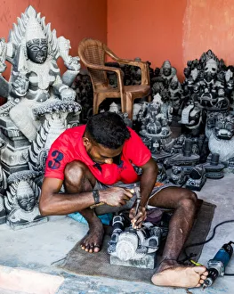 A stone carver at Mamallapuram in Tamil Nadu, India
